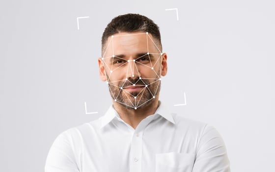 A man poses with a facial recognition overlay, showcasing modern technology's integration with human expression. photo