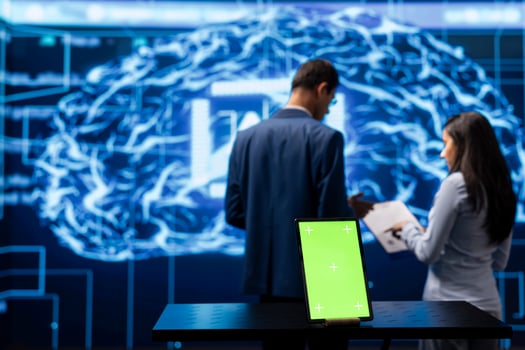 Technicians using green screen tablet and AI neural networks modeled after human brain to solve complex problems. Workers using artificial intelligence and mockup device to look at company data photo
