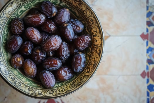 A bowl of dates on a table photo