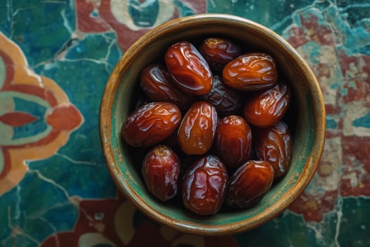 A bowl of dates on a colorful table photo