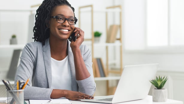 Customer Communications. Office Girl Having Phone Conversation With Client Sitting At Laptop In Modern Office. Free Space photo
