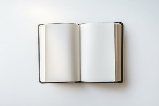 An open blank notebook lying flat, ready for writing, with clean white pages and a minimalist background photo