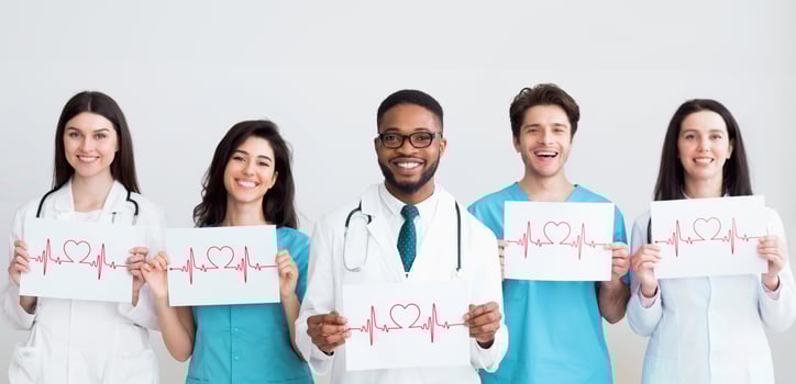 Doctors holding papers with cadiograms of heartbeat, grey background photo