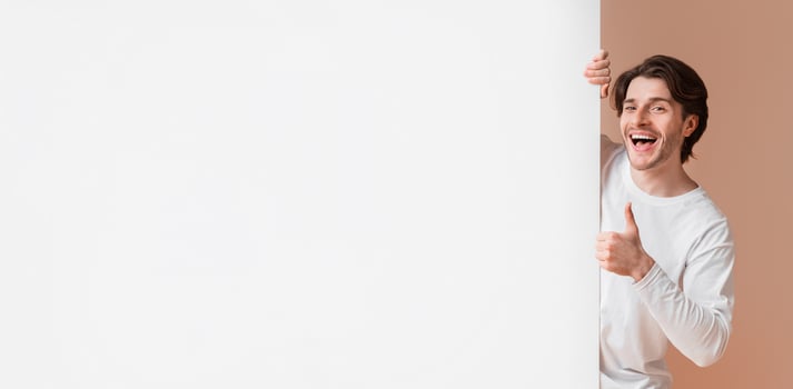 Happy Interracial Couple Holding White Advertising Board And Showing Thumbs Up, Recommending Something Over Yellow Studio Background, Free Space photo