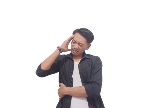 A man in a black shirt holds his head with a pained expression, indicating a headache or discomfort. The plain white background emphasizes his distress and highlights his posture and expression. photo