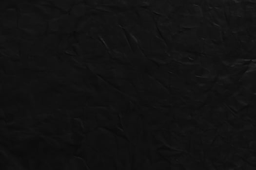 Close-up of Black Corduroy Fabric on Dark Background photo