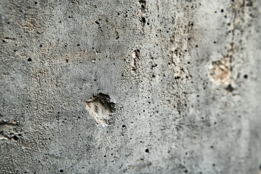 A Close-Up of a Grey, Rough, Pitted Surface photo