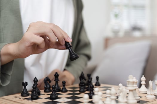 Young Teenager Sitting and Playing Chess at Home, Focused on Strategy and Concentration, Indoor Activity photo