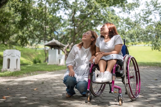 Young Disabled Woman in Wheelchair and Best Friend Enjoying a Relaxing Day in the Park photo