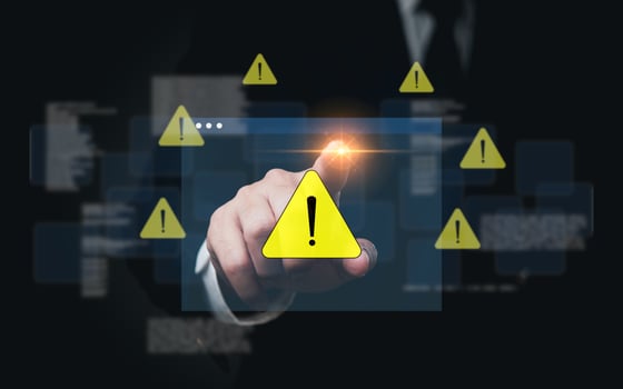Businessman activating digital warning symbol. Highlight on cybersecurity risk. Perfect for security, tech, IT presentations. photo