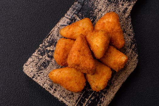 Breaded camembert or brie cheese baked in the form of nuggets with salt and spices photo