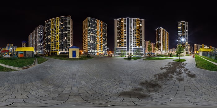 night panorama 360 near skyscraper multistory buildings with illumination of residential quarter complex in full equirectangular seamless spherical projection photo