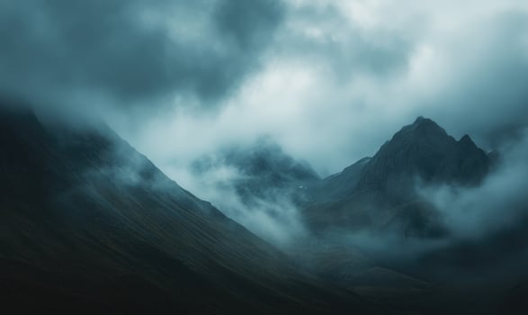 Dark clouds looming over a jagged mountain range photo