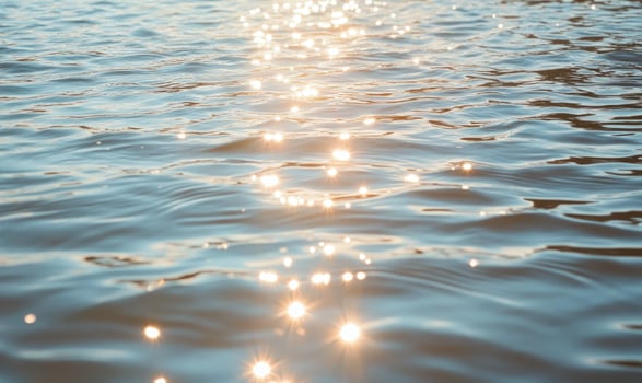 Close-up of small waves in a lake, sunlight sparkling on the water photo