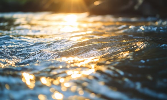 Close-up of a flowing river, sunlight reflecting on the water photo