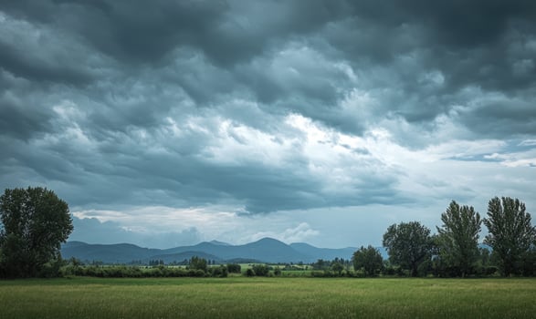Dark, overcast sky looming above a quiet countryside photo