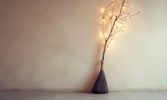 Witch's broom adorned with glowing garlands photo