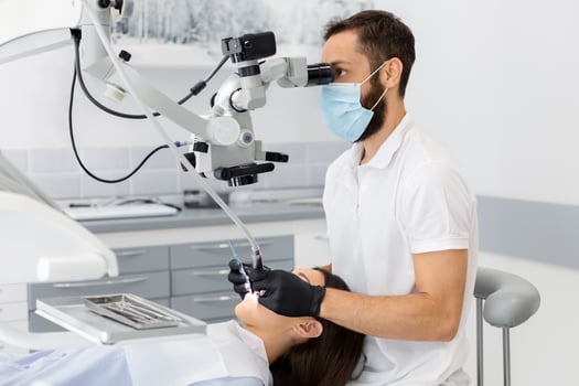 Professional bearded male dentist using modern technologies in dental treatment, complicated cases in stomatology photo