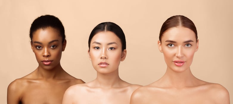 Female Beauty Concept. Three Multicultural Model Girls Posing Wearing Underwear Looking At Camera Over Gray Studio Background. photo