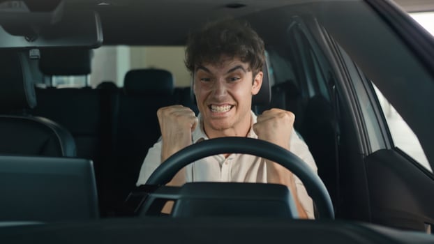 Smiling positive successful happy Caucasian man excited with new luxury car make winner hands gesture achieve triumph enjoy automobile buying male client buy vehicle transport celebrate sitting inside photo