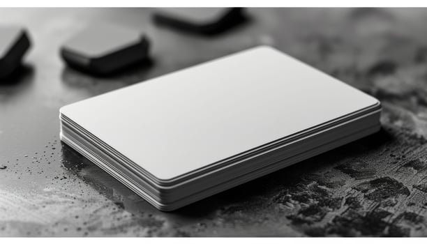 A stack of white business cards sits on a table photo