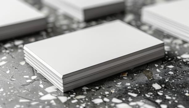 A stack of white business cards with a white card in the middle photo