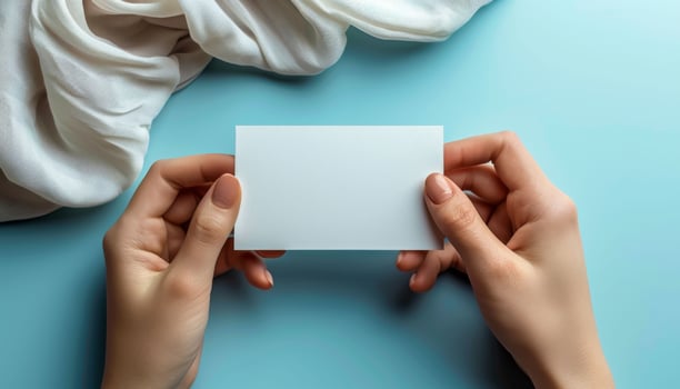 A woman holds a blank business card in her hand photo