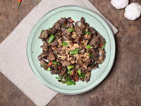 Tumis Ati Goreng is a popular Indonesian stir-fried chicken liver dish typically includes tender chicken liver, sauted with aromatic spices like garlic, ginger, and chili. photo