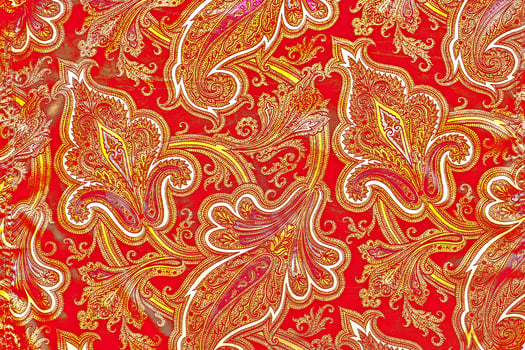 Red yellow fabric textile with bizarre leaves and flowers photo