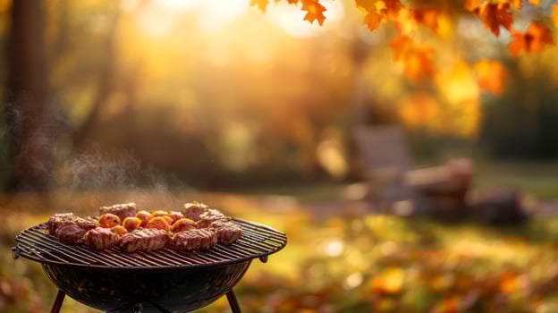 Enjoy a joyful autumn barbecue with deliciously grilled meats amidst a stunning outdoor backdrop of vibrant fall colors, elevating the experience to new heights of enjoyment and warmth photo