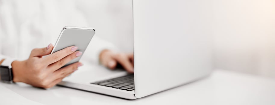 Modern Technologies. Closeup of woman using laptop and mobile phone, writing post. Free space photo