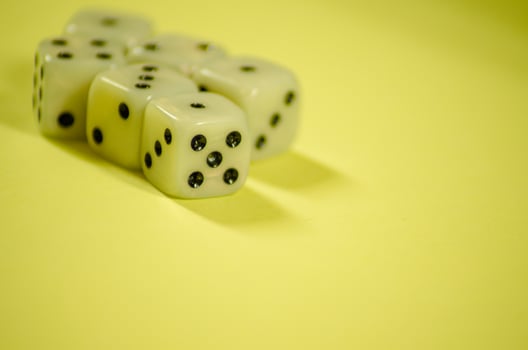 six six-sided white dice on yellow background photo