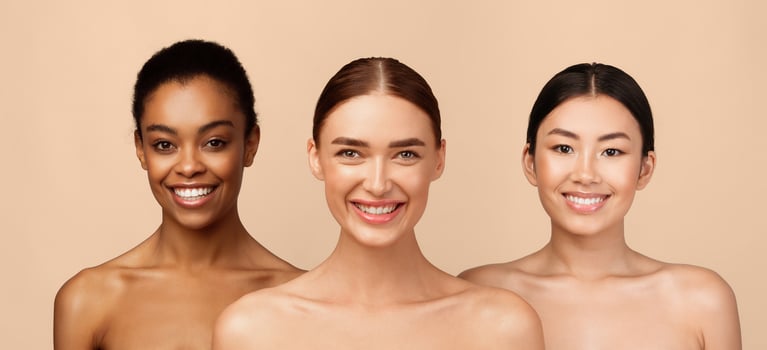 Three Happy Diverse Girls Wrapped In White Towels Posing Standing On Gray Studio Background, Smiling To Camera. Body Care Concept photo