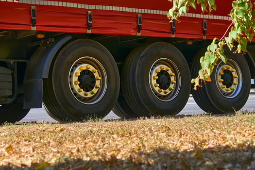 Three large wheels of a heavy duty long haul trailer photo