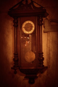 Old vintage clock hanging on the wall photo