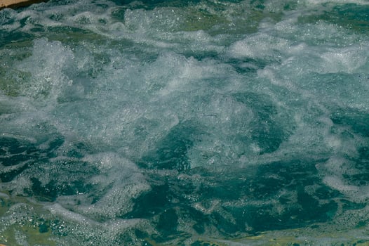 A blue pool shines on a summer day photo