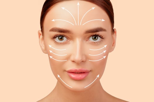 Lifted and Rejuvenated. Pretty Young Woman's Face With Lifting Arrows On Perfect Smooth Skin, Beauty Portrait On White Studio Background. Plastic Surgery And Antiaging Facial Massage Concept photo