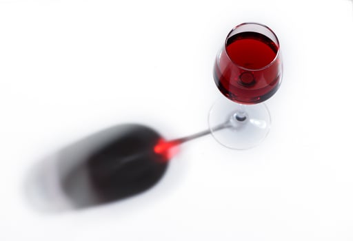 Shadow from wine glass on white background photo