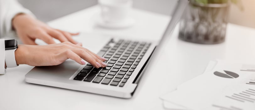 Freelance. Close up of woman using laptop, working at home, writing a blog, hands on keyboard. Copyspace photo