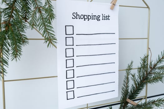 Holiday preparation paper note with SHOPPING LIST checklist text. Vision board wall with cozy minimalistic handmade new year Christmas decor Low key festive celebration concept photo