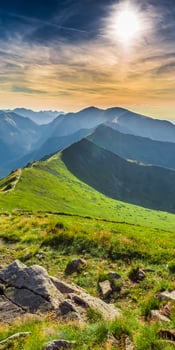 The sun shines over the mountains in the morning photo