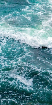 A person on a surfboard riding a wave photo
