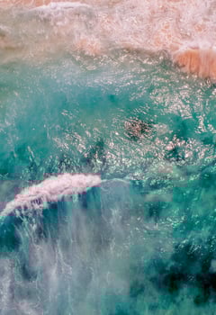An aerial view of a wave breaking on the ocean photo