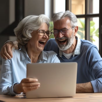 Older people laughing near a laptop. Family, couple, husband and wife. photo