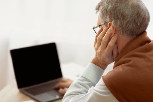 Unrecognizable Senior Man Using Laptop Looking At Blank Screen Sitting In Office. Mockup, Back View photo