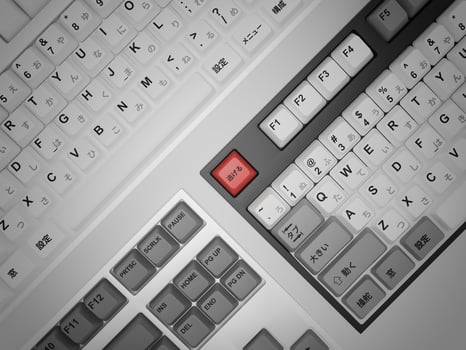 A keyboard with a red key on it photo