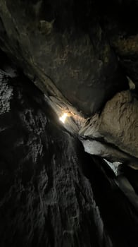 Sun rays pass through the stones in a cave. Poland photo