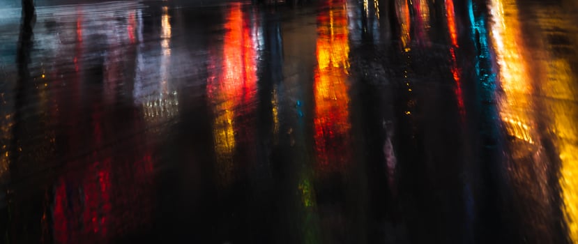 A blurry picture of a street at night with lights photo
