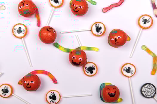 Halloween candy with black spiders on white background photo
