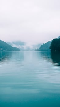 A calm lake with mountains in the background photo